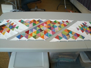 Lay out your center and end sections as shown and sew together to complete your tablerunner top. 